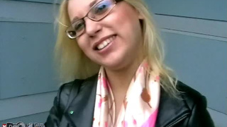 Busty blonde teen with glasses is giving blowjob in public place